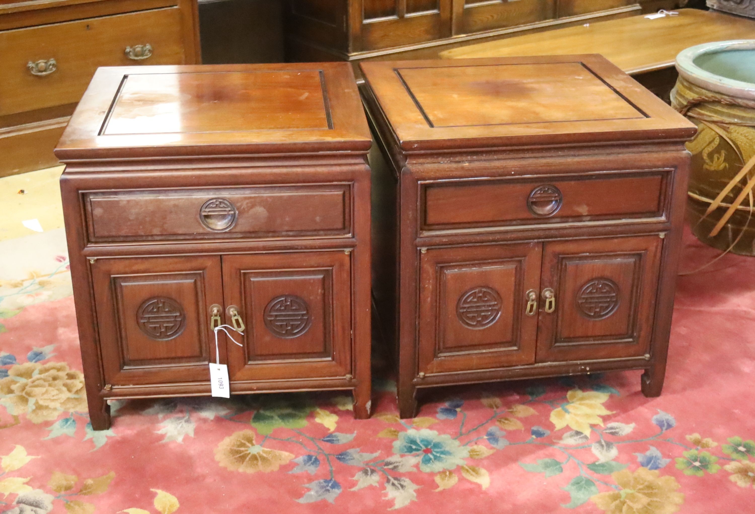 A pair of Chinese carved hardwood low cabinets, width 56cm, depth 56cm, height 59cm